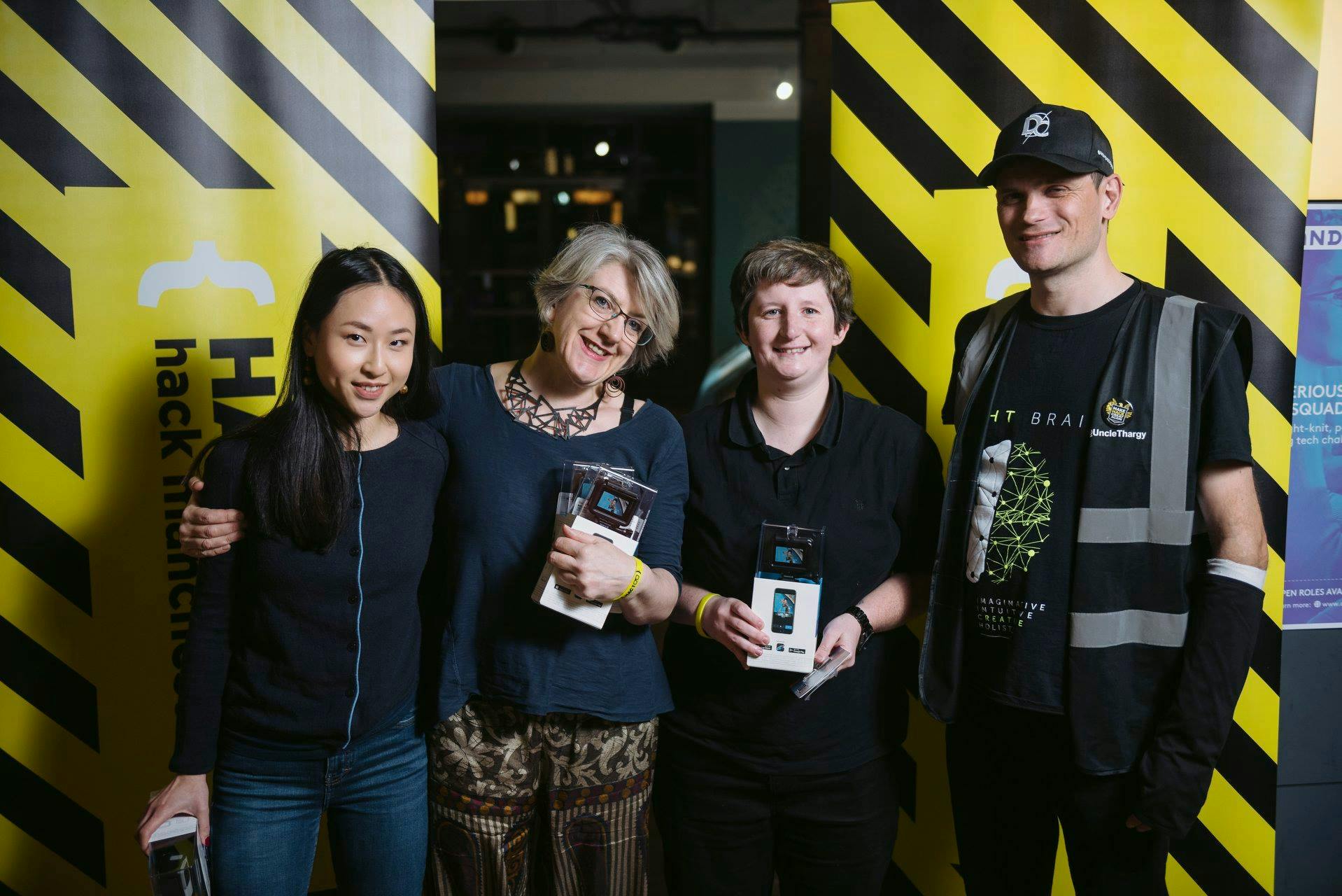 A photo of our team (minus Sal) accepting our awards at Hack Manchester 2018